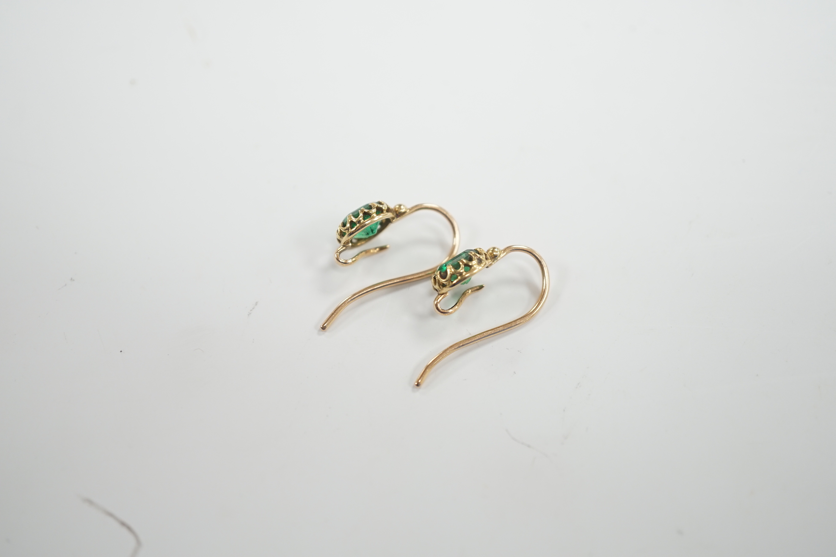 A pair of Victorian yellow metal and emerald set earrings (lacking drops), 6mm diameter, gross weight 2.5 grams